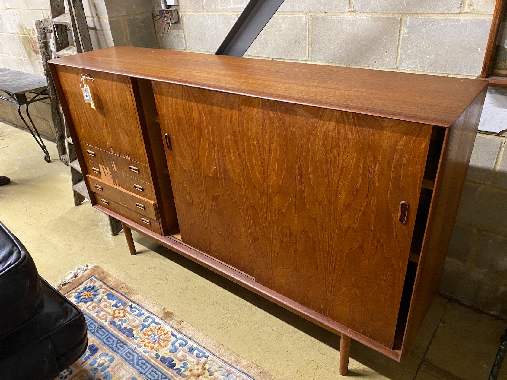 A mid century teak side cabinet (with faults), length 198cm, depth 45cm, height 121cm